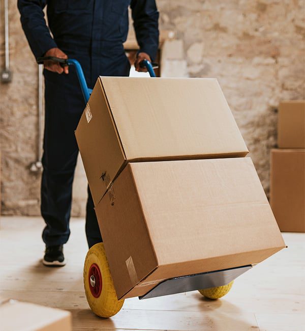 Person moving boxes on a hand truck