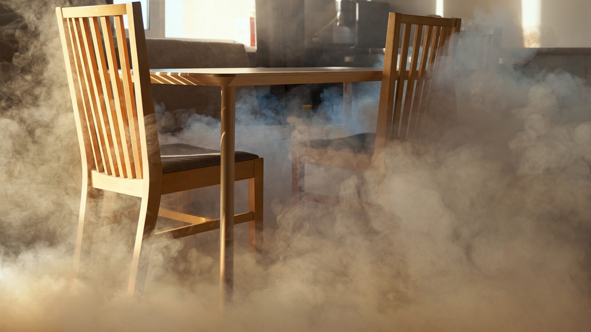 Dining table and chairs surrounded by smoke