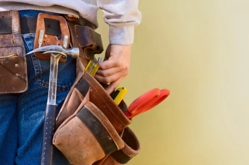 Worker wearing a leather tool belt